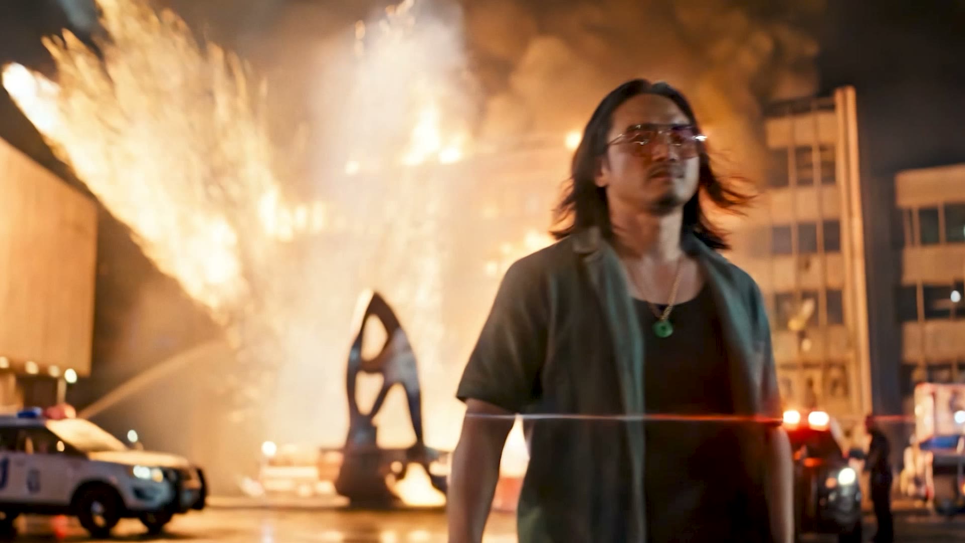 The photographer walks away as the building explodes behind him